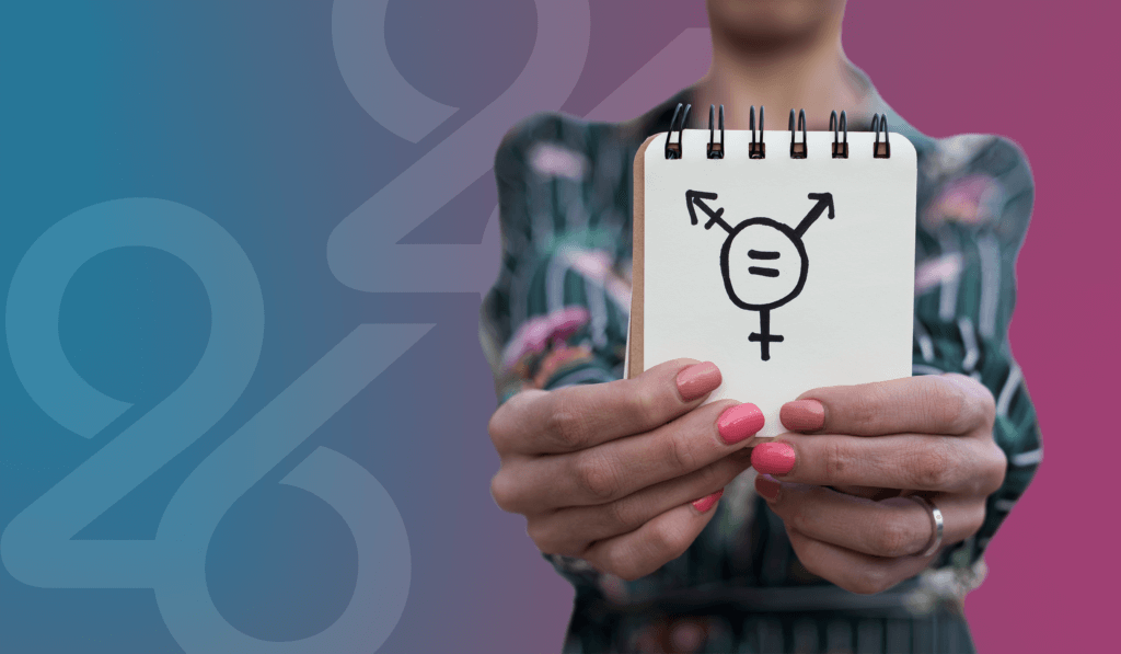 Person extending out hands holding up a notepad with gender equality symbol drawn in black ink