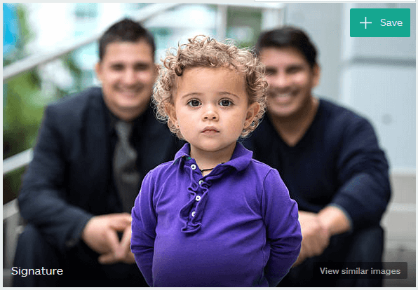 Portrait of small child in purple shirt standing in front of adoptive parents