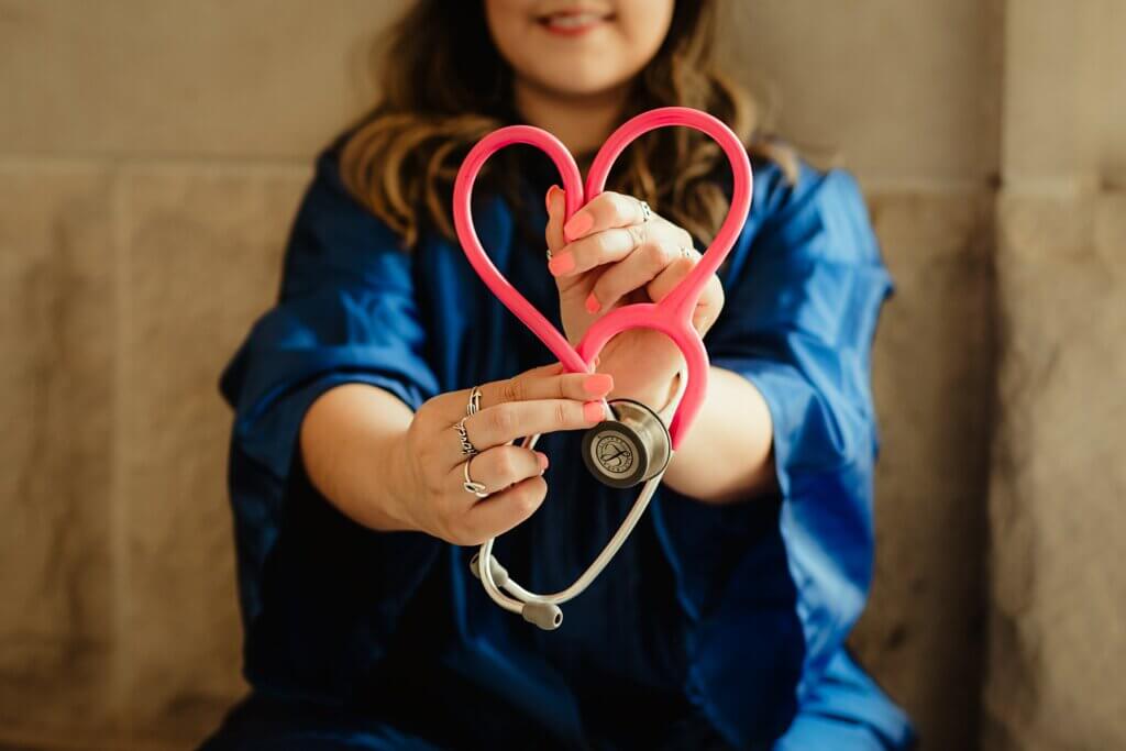 Nursing holding stethoscope in the shape of a heart