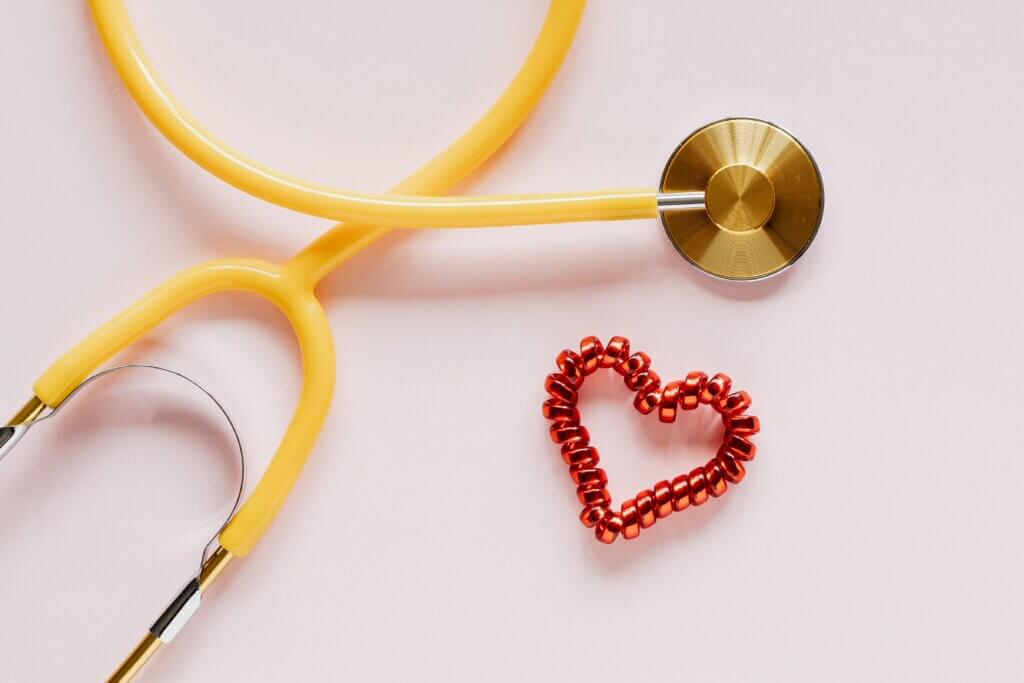 Stethoscope placed alongside heart shaped wrist band