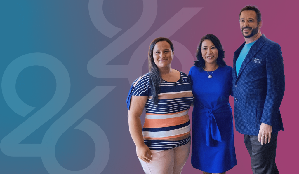 Three individuals wearing professional work attire while smiling