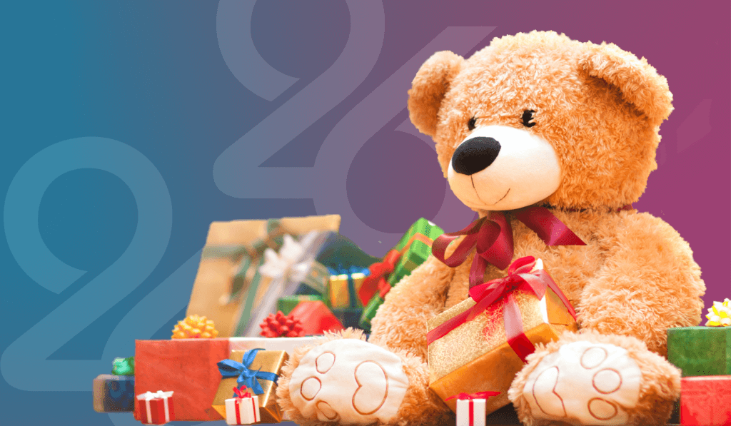 Light brown teddy bear sitting with wrapped presents