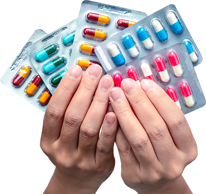 Close-up of two hands holding blister packs of various colorful capsules, including red and yellow, green and yellow, and blue and white pills. The image is well-lit and shows a variety of medication options.