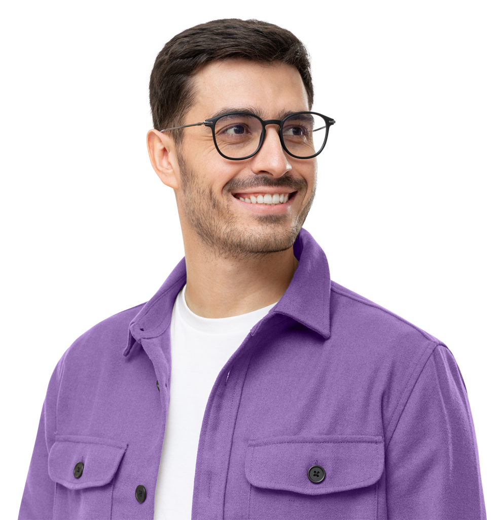 A man with short dark hair and a beard is smiling while wearing glasses, a white shirt, and a purple jacket. He is looking to his right. The background is white.